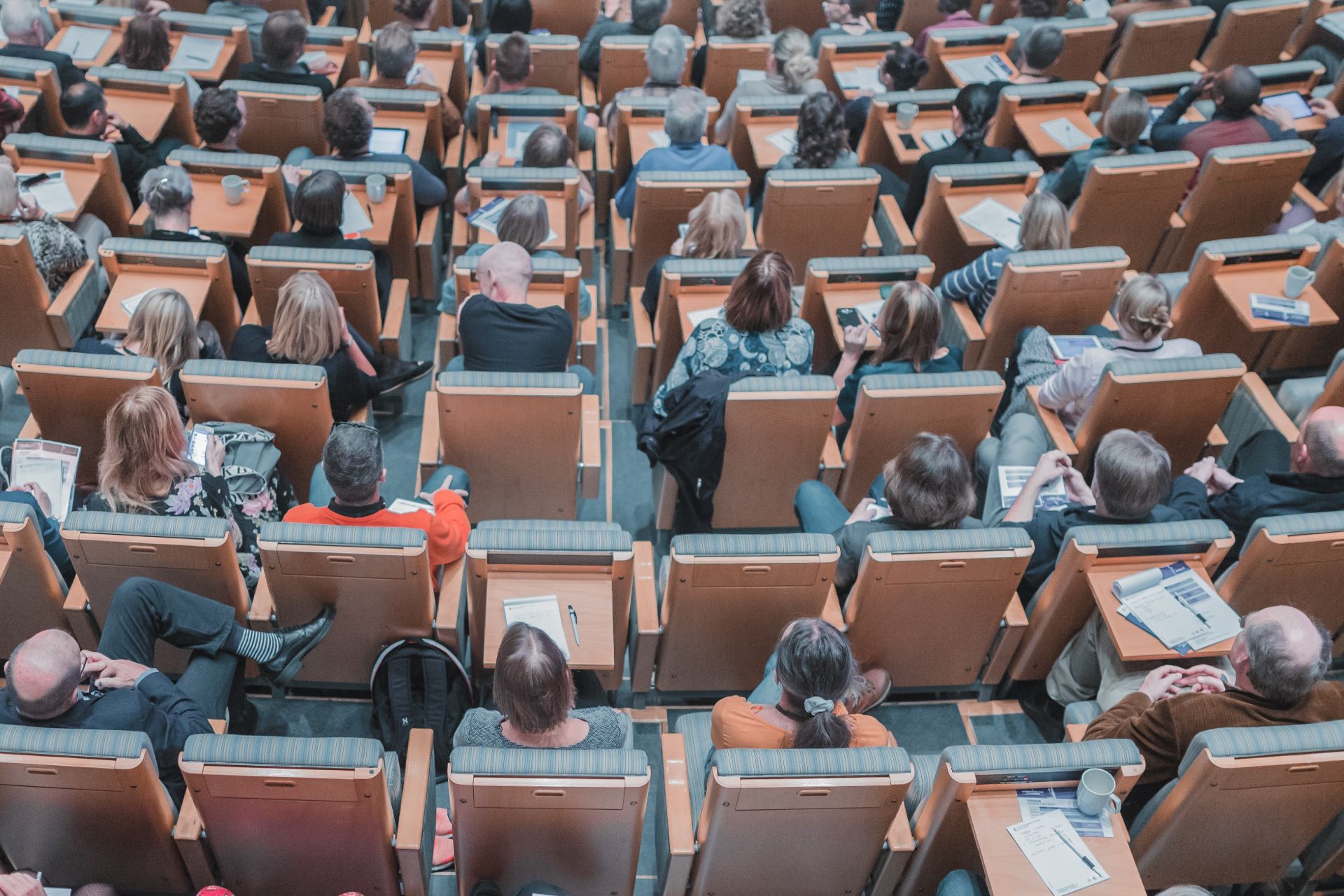 photo from above of people sitting in lecture hall